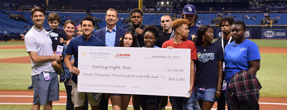 Crown Automotive Group dealership President Jim Myers presents the $20,350 "Strikeout Challenge" check to Vicki Sokolik, Founder and Executive Director of nonprofit Starting Right, Now